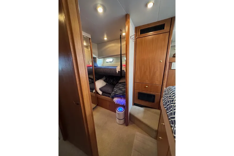 Slide: The Image of 1998 Bayliner 4788 Pilot House Motoryacht interior hallway with wooden accents and glass shower. - 38