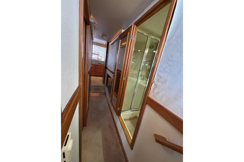 Slide: The Image of Interior hallway of 1998 Bayliner 4788 Pilot House Motoryacht, featuring wood accents and cozy design. - 39