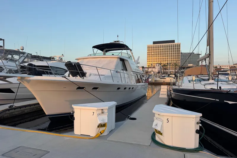 Slide: The Image of 1998 Bayliner 4788 Pilot House Motoryacht docked at marina during sunset. - 4
