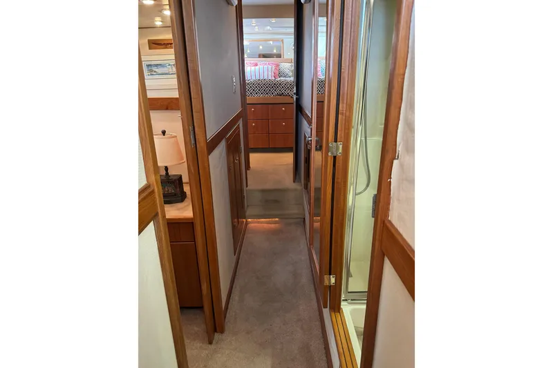 Slide: The Image of 1998 Bayliner 4788 Pilot House Motoryacht interior hallway with wood accents and cozy cabin view. - 40