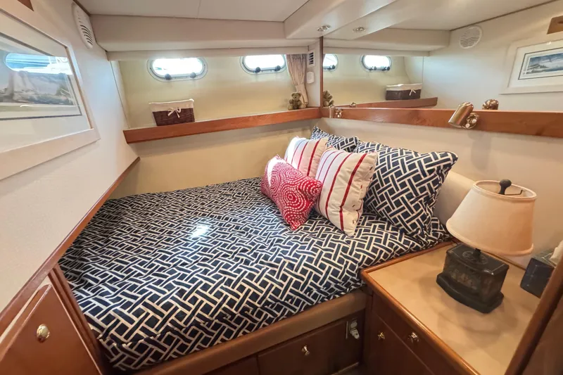 Slide: The Image of Luxurious bedroom in 1998 Bayliner 4788 Pilot House Motoryacht with elegant bedding and wood cabinetry. - 44