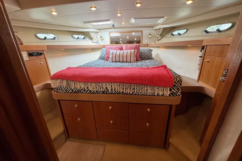 Slide: The Image of Luxurious bedroom interior of 1998 Bayliner 4788 Pilot House Motoryacht with patterned bedding. - 45