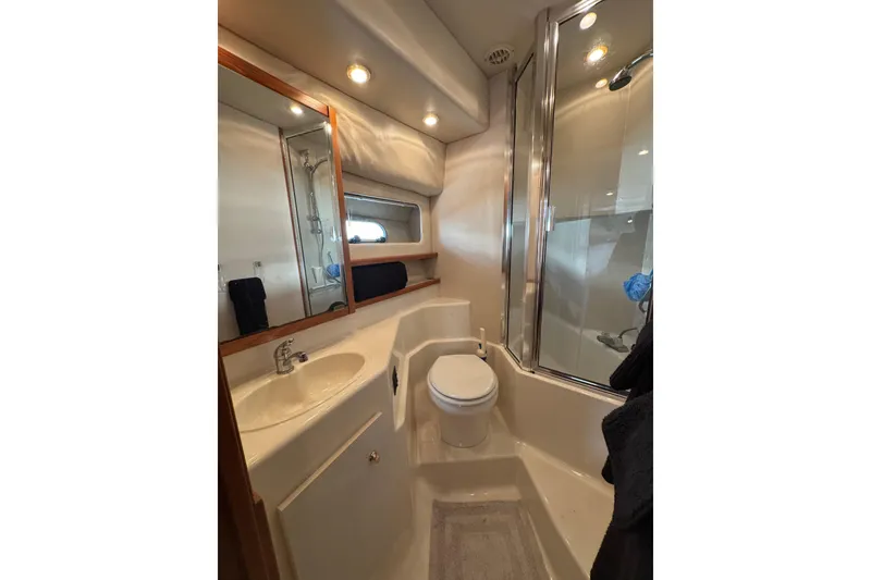 Slide: The Image of Shower area in 1998 Bayliner 4788 Pilot House Motoryacht, featuring chrome fixtures. - 51