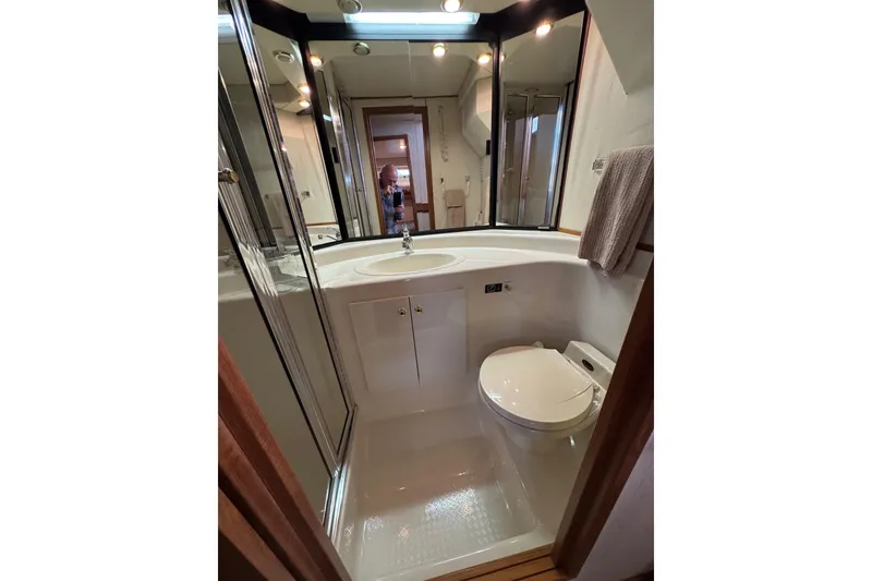Slide: The Image of Shower area in 1998 Bayliner 4788 Pilot House Motoryacht with blue loofah and chrome fixtures. - 52