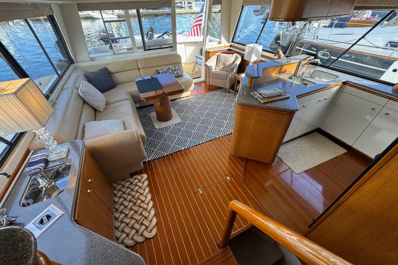 Slide: The Image of Luxurious interior of 1998 Bayliner 4788 Pilot House Motoryacht with elegant seating and kitchen area. - 58