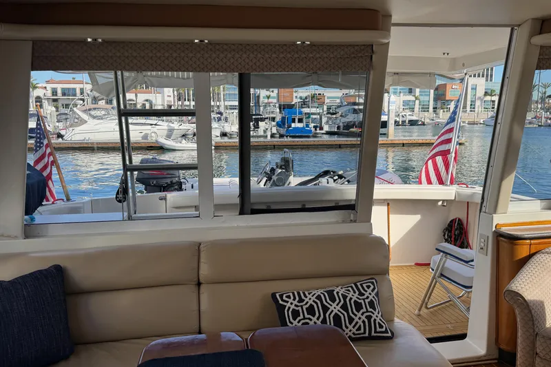 Slide: The Image of Interior view of 1998 Bayliner 4788 Pilot House Motoryacht with marina backdrop. - 64