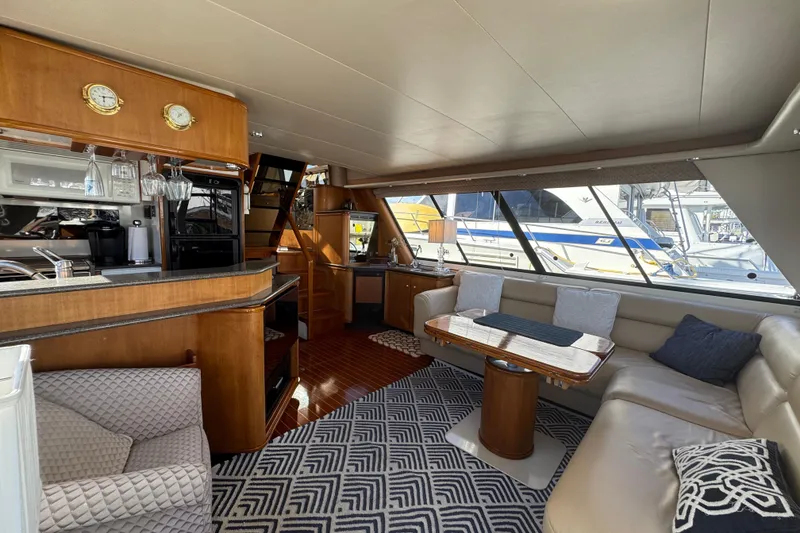 Slide: The Image of Luxurious interior of 1998 Bayliner 4788 Pilot House Motoryacht with elegant seating and kitchen area. - 69