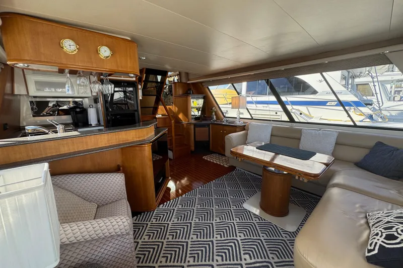 Slide: The Image of Luxurious interior of 1998 Bayliner 4788 Pilot House Motoryacht with elegant seating and dining area. - 70