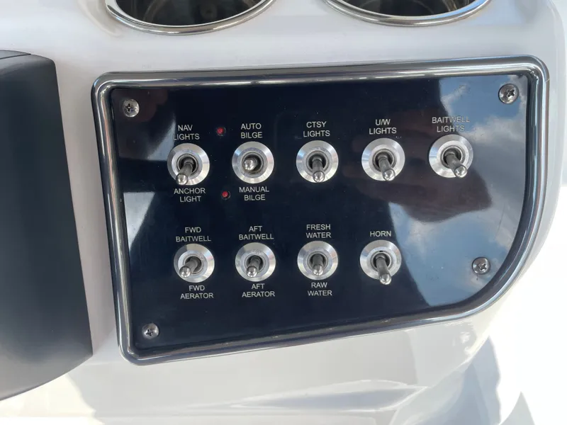Slide: The Image of Control panel of 2024 NauticStar 191H boat with various switches and functions. - 15
