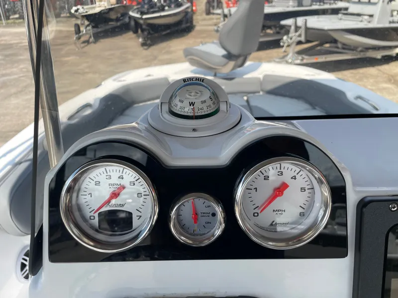 Slide: The Image of 2024 NauticStar 191H dashboard with gauges and compass, showcasing RPM and speed indicators. - 17