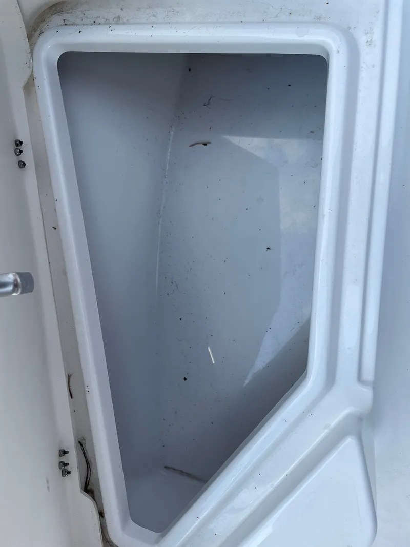 Slide: The Image of Storage compartment of 2024 NauticStar 191H boat, open and empty. - 22