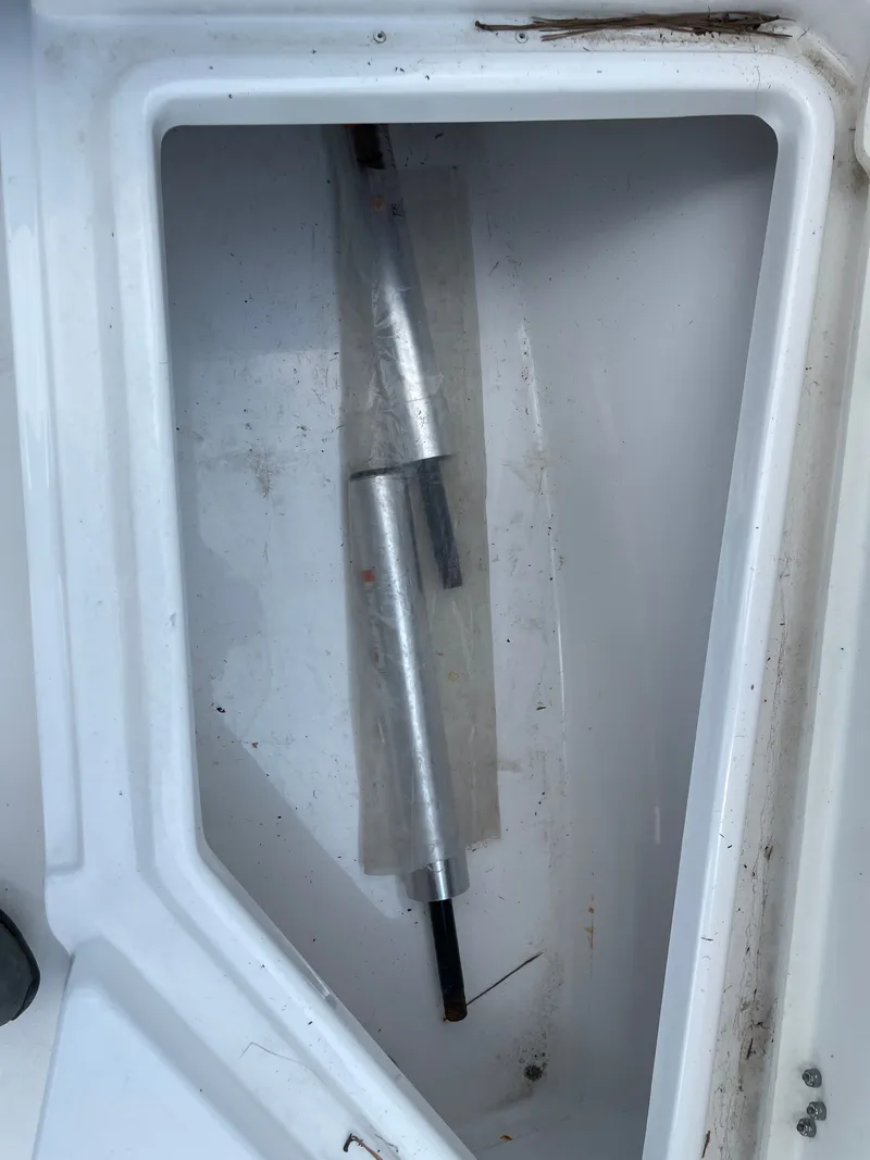 Slide: The Image of Storage compartment of 2024 NauticStar 191H boat with metal rod inside. - 24