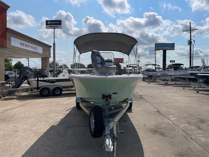 Slide: The Image of 2024 NauticStar 191H boat on trailer at dealership under cloudy sky. - 5