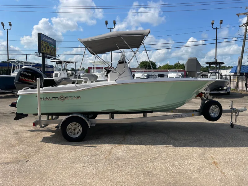 Slide: The Image of 2024 NauticStar 191H boat on trailer, outdoor display, clear sky background. - 7