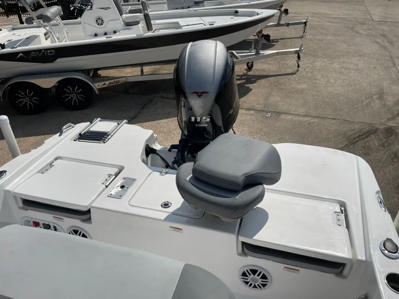 Slide: The Image of 2024 NauticStar 191H boat with Yamaha 115 engine, docked on a trailer. - 9