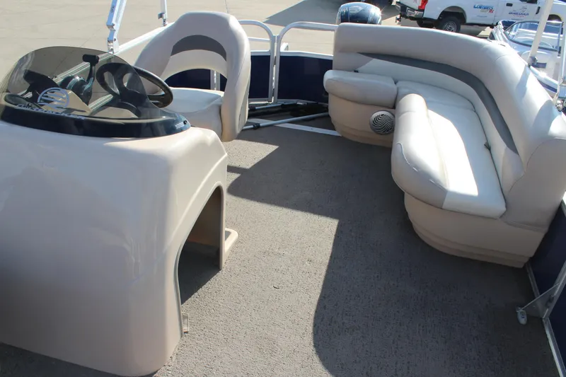 Slide: The Image of 2016 Sun Tracker Party Barge 16 DLX interior with seating and steering console. - 11