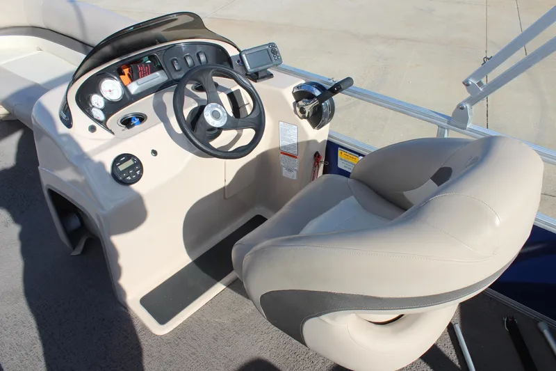 Slide: The Image of 2016 Sun Tracker Party Barge 16 DLX helm with steering wheel and controls. - 12