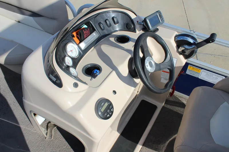 Slide: The Image of 2016 Sun Tracker Party Barge 16 DLX steering console with gauges and controls. - 14