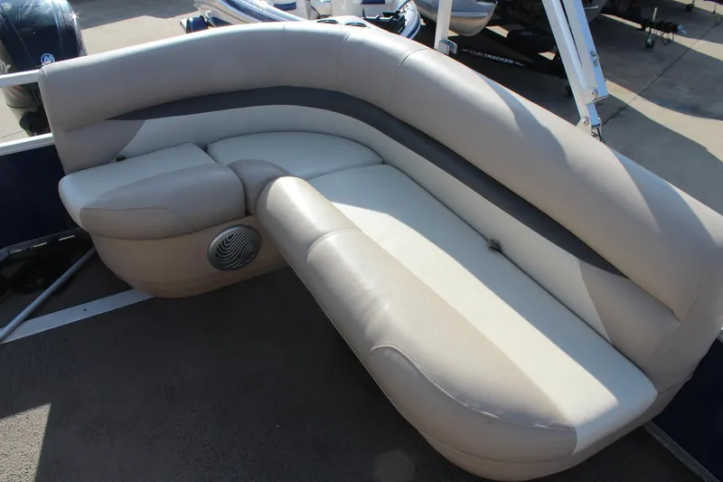 Slide: The Image of 2016 Sun Tracker Party Barge 16 DLX, beige seating with integrated speaker. - 16
