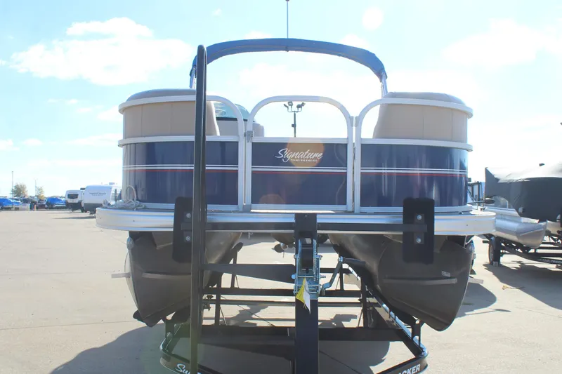 Slide: The Image of 2016 Sun Tracker Party Barge 16 DLX pontoon boat on trailer, rear view. - 2