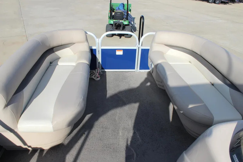 Slide: The Image of 2016 Sun Tracker Party Barge 16 DLX interior with beige seating and open deck space. - 22
