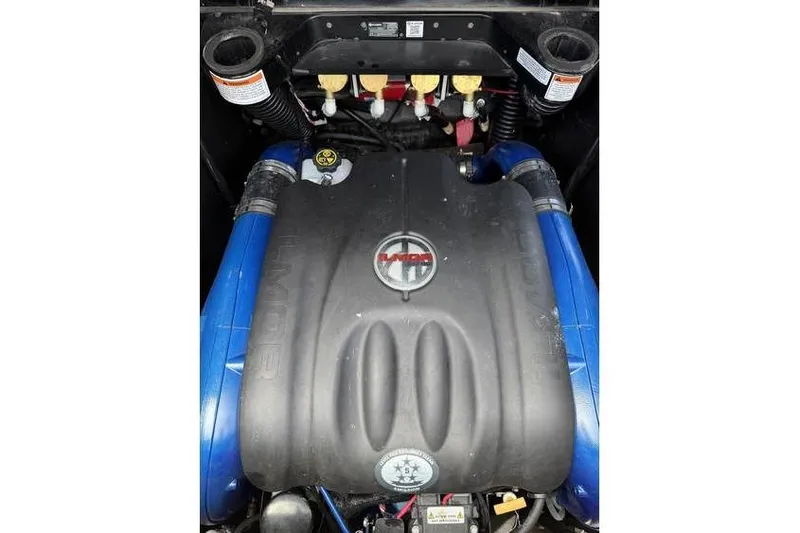 Slide: The Image of 2021 MasterCraft X24 engine with blue hoses and black cover. - 5
