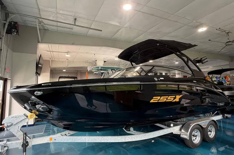 The Image of 2026 Yamaha Boats 255 XD displayed indoors on a trailer. - 0