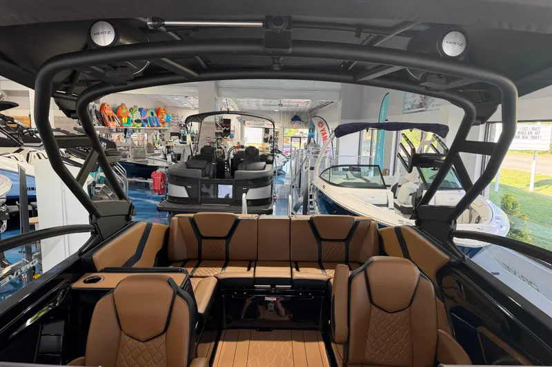 Slide: The Image of 2026 Yamaha Boats 255 XD interior with luxurious seating in showroom. - 18