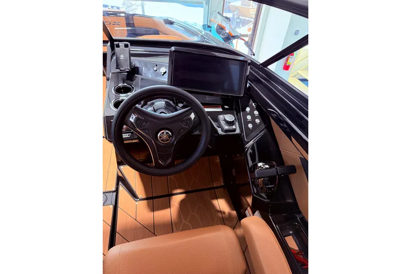 Slide: The Image of 2026 Yamaha Boats 255 XD helm with modern steering wheel and touchscreen display. - 22