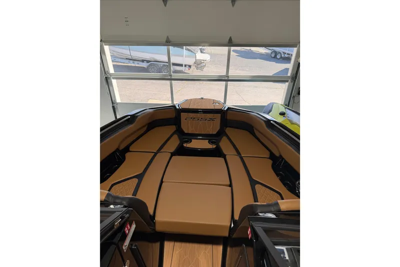 Slide: The Image of 2026 Yamaha Boats 255 XD interior with tan seating, showcasing luxury and comfort. - 23