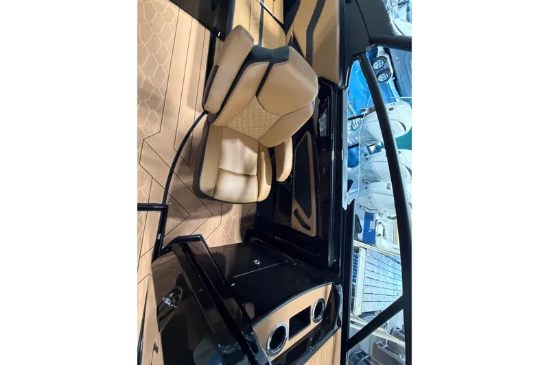 Slide: The Image of Luxurious interior of 2026 Yamaha Boats 255 XD with tan seating and sleek dashboard. - 5