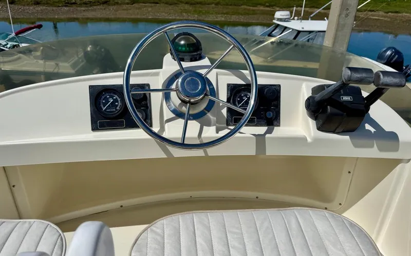 Slide: The Image of Steering console of a 2004 Rodman 800 boat with gauges and controls. - 11