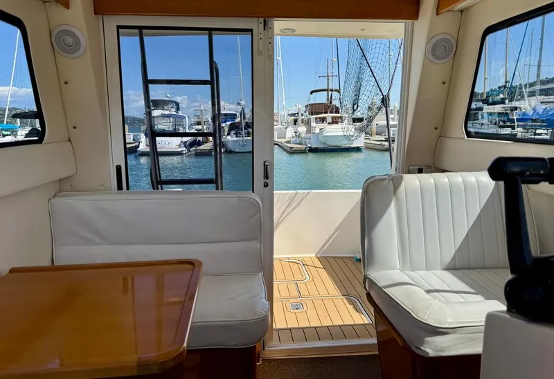Slide: The Image of Interior of a 2004 Rodman 800 boat with marina view through windows. - 16
