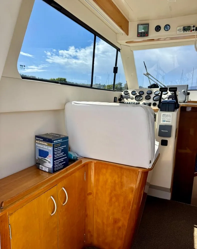 Slide: The Image of Interior of a 2004 Rodman 800 boat with control panel and seating. - 18