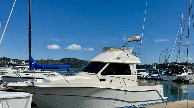 Slide: The Image of 2004 Rodman 800 boat docked at a marina under clear blue skies. - 3