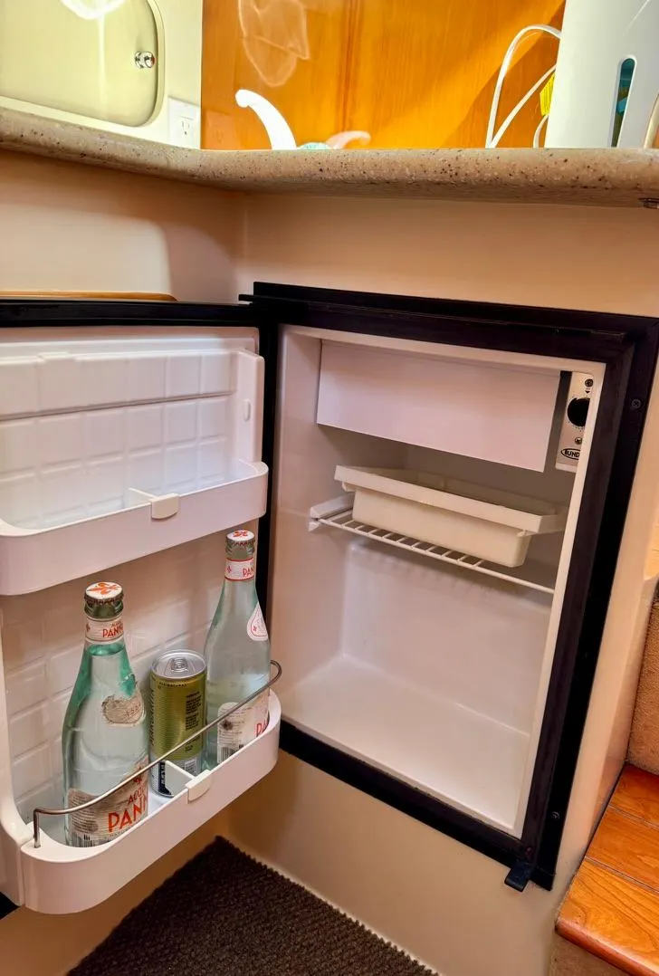 Slide: The Image of Mini fridge in 2004 Rodman 800 boat interior, stocked with beverages. - 30