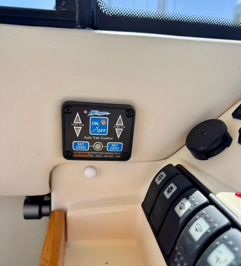 Slide: The Image of Control panel of a 2004 Rodman 800 boat with auto tab controller. - 32