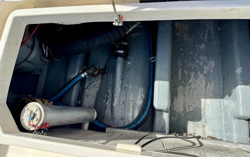 Slide: The Image of Engine compartment of a 2004 Rodman 800 boat, showing hoses and mechanical components. - 43