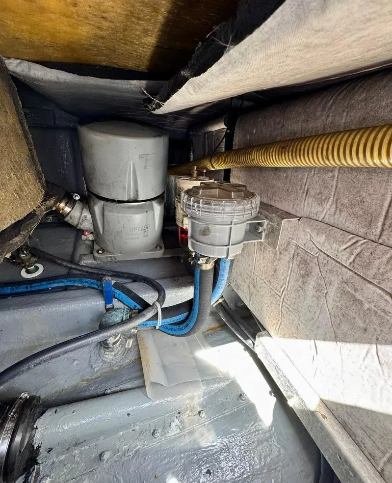 Slide: The Image of Engine compartment of a 2004 Rodman 800 boat, showing mechanical components and wiring. - 44