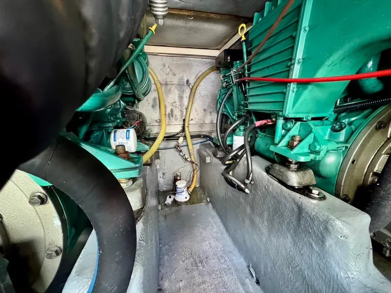 Slide: The Image of Engine compartment of a 2004 Rodman 800 boat, showcasing mechanical components and wiring. - 46