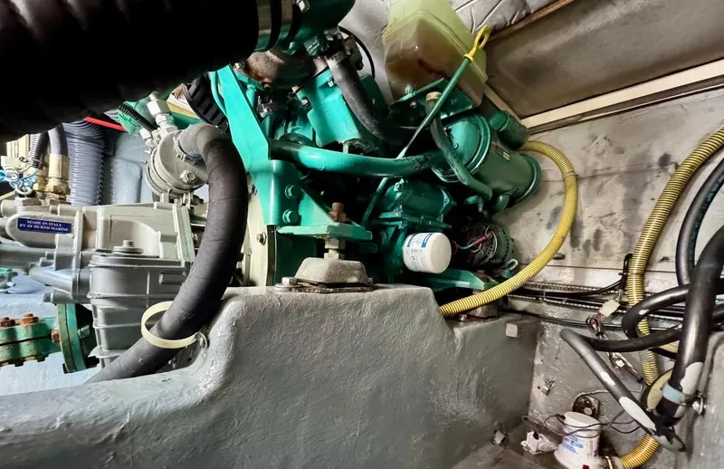 Slide: The Image of Engine compartment of a 2004 Rodman 800 boat, showcasing mechanical components and wiring. - 47