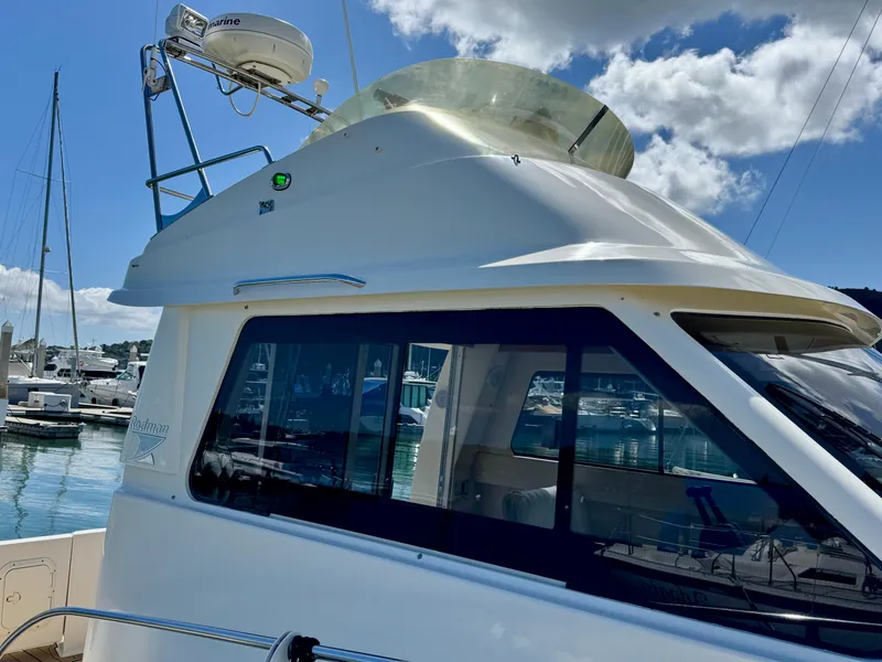 Slide: The Image of 2004 Rodman 800 boat docked at marina under blue sky. - 5
