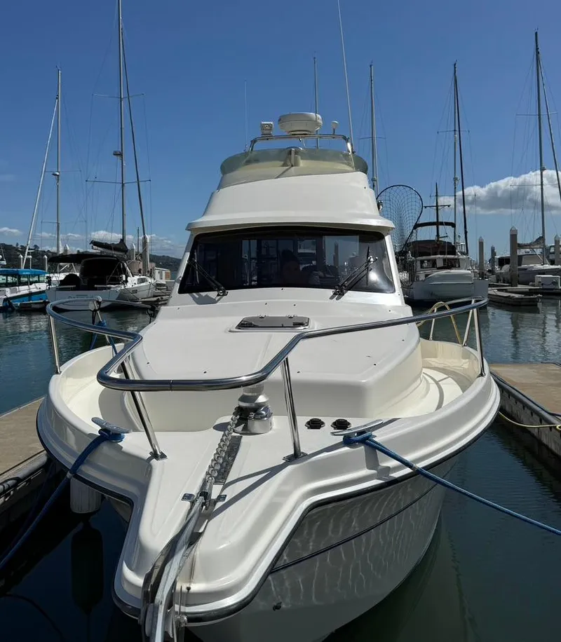 Slide: The Image of 2004 Rodman 800 boat docked at a marina, surrounded by other vessels. - 6