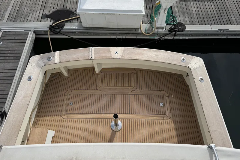 Slide: The Image of 1991 Viking 53 Convertible yacht docked at marina under cloudy sky. - 11