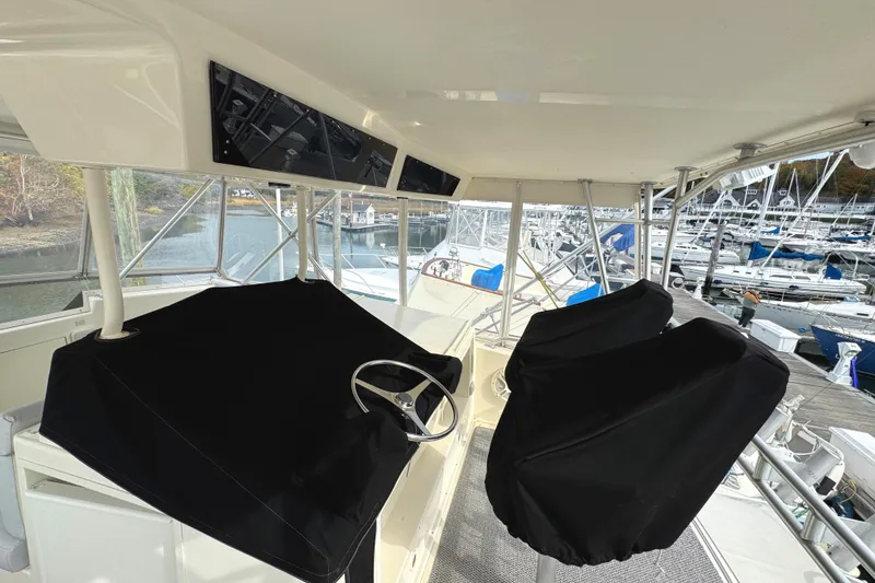 Slide: The Image of 1991 Viking 53 Convertible yacht deck with ladder and seating area. - 12