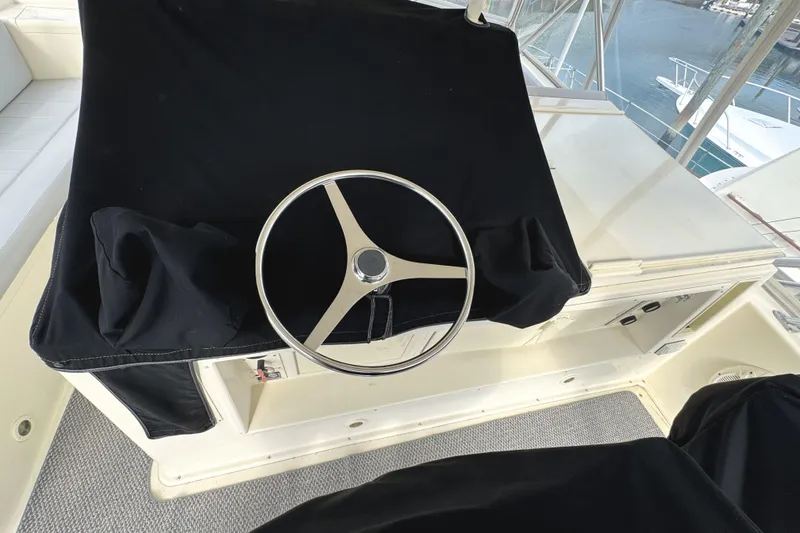 Slide: The Image of 1991 Viking 53 Convertible boat deck with wooden finish, docked at marina. - 13