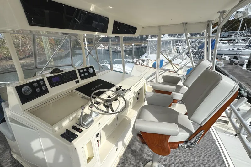 Slide: The Image of Steering wheel of a 1991 Viking 53 Convertible yacht, covered in black fabric. - 15