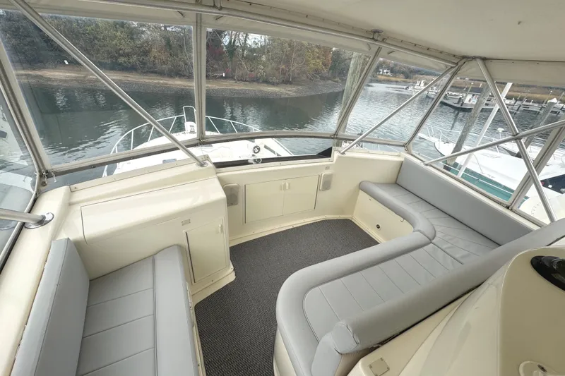 Slide: The Image of Captain's chairs on 1991 Viking 53 Convertible yacht, featuring wood accents and control panel. - 19