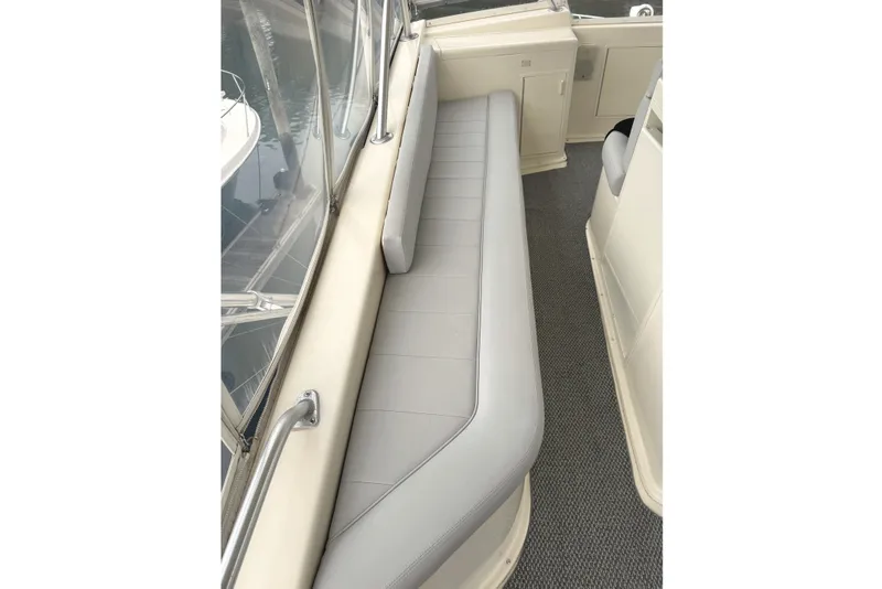 Slide: The Image of 1991 Viking 53 Convertible yacht interior with gray seating and marina view. - 23