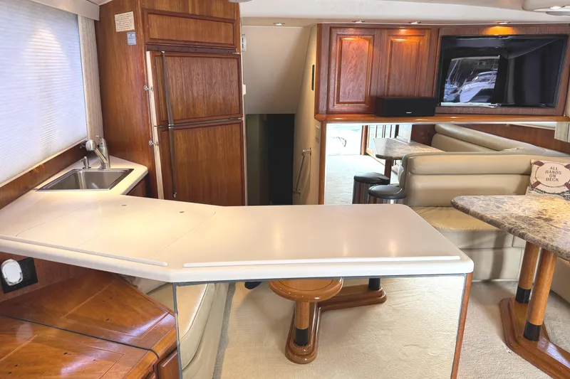 Slide: The Image of Luxurious interior of a 1991 Viking 53 Convertible yacht with elegant wood finishes. - 29